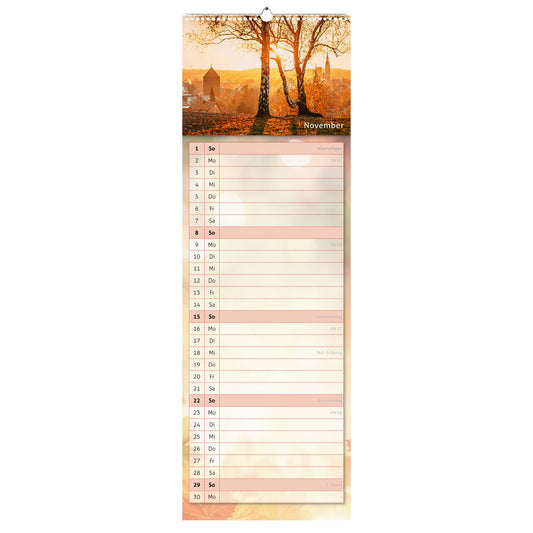 November-Motiv des Küchenkalenders 2026: Blick über Freiberg von der Haldenkante, mit Donatsturm und Petrikirche in goldenes Licht getaucht.