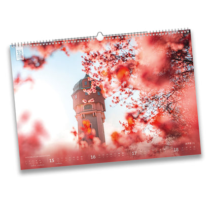 Kalenderblatt April 2026: Wasserturm in Freiberg, eingerahmt von blühenden Kirschblüten, stimmungsvolles Frühlingsmotiv.