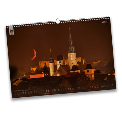 Septemberblatt des Bergstadtkalenders 2026 mit Blick auf die Freiberger Altstadt bei Nacht, der Mond geht hinter der Stadtsilhouette unter, gesehen von der Halde der KGV-Anlage Silberblick.
