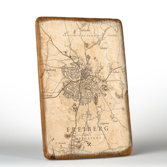 Wandbild „Freiberg die Bergstadt“ auf Vintage-Holz. Zeigt eine historische Landkarte von Freiberg, direkt auf Echtholzplatte im UV-Druck gefertigt, mit rustikalem, abgerundetem Rand und typischen Maserungen, Rissen und Astlöchern für authentischen Vintage-Charakter.